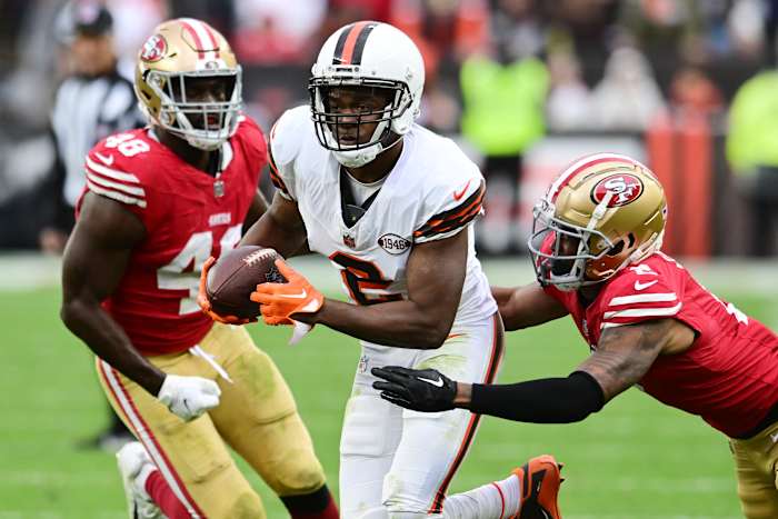 Oct 15, 2023; Cleveland, Ohio, USA; Cleveland Browns wide receiver Amari Cooper (2) runs with the ball after a catch as San Francisco 49ers cornerback Deommodore Lenoir (2) and linebacker Oren Burks (48) defend during the second half at Cleveland Browns Stadium.